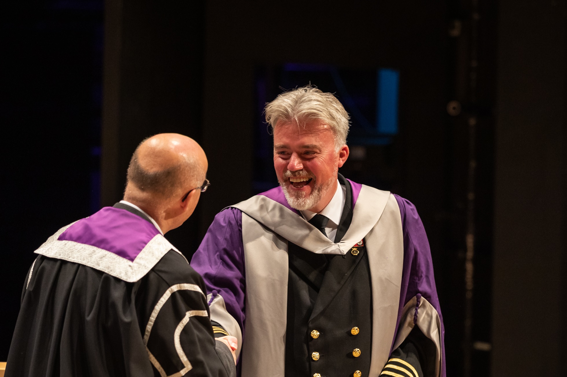 Captain Iain Macneil presented with an Honorary Doctorate for services to education in the maritime sector by Professor Neil Simco of UHI.
